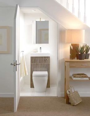 a small toilet under the staircase. brown and pattern 