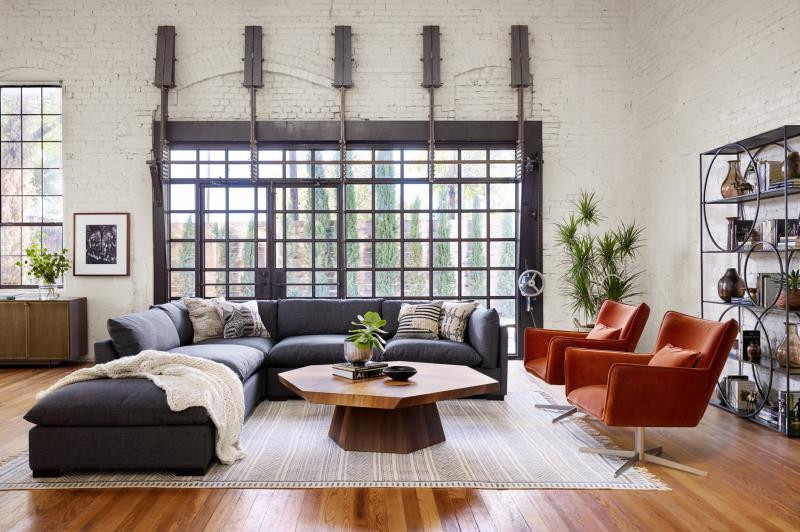 Four Hands Living Room with sectional and orange chairs