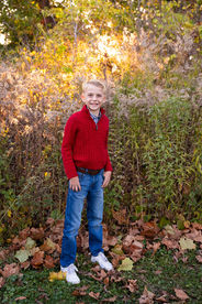 Young boy in red shirt in front of the prairie grasses in the fabyan forest preserve in Geneva IL