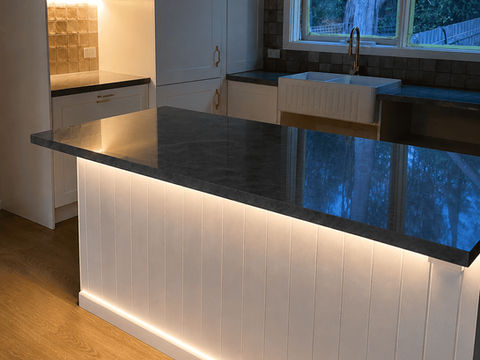 Modern kitchen island with warm LED strip lighting