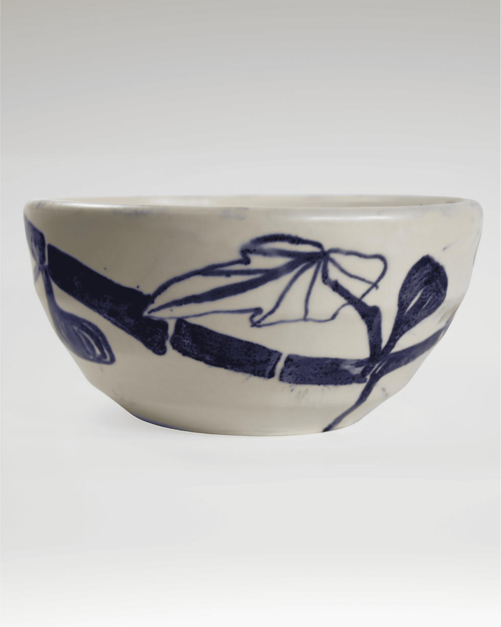 White ceramic bowl with blue botanical illustrations.