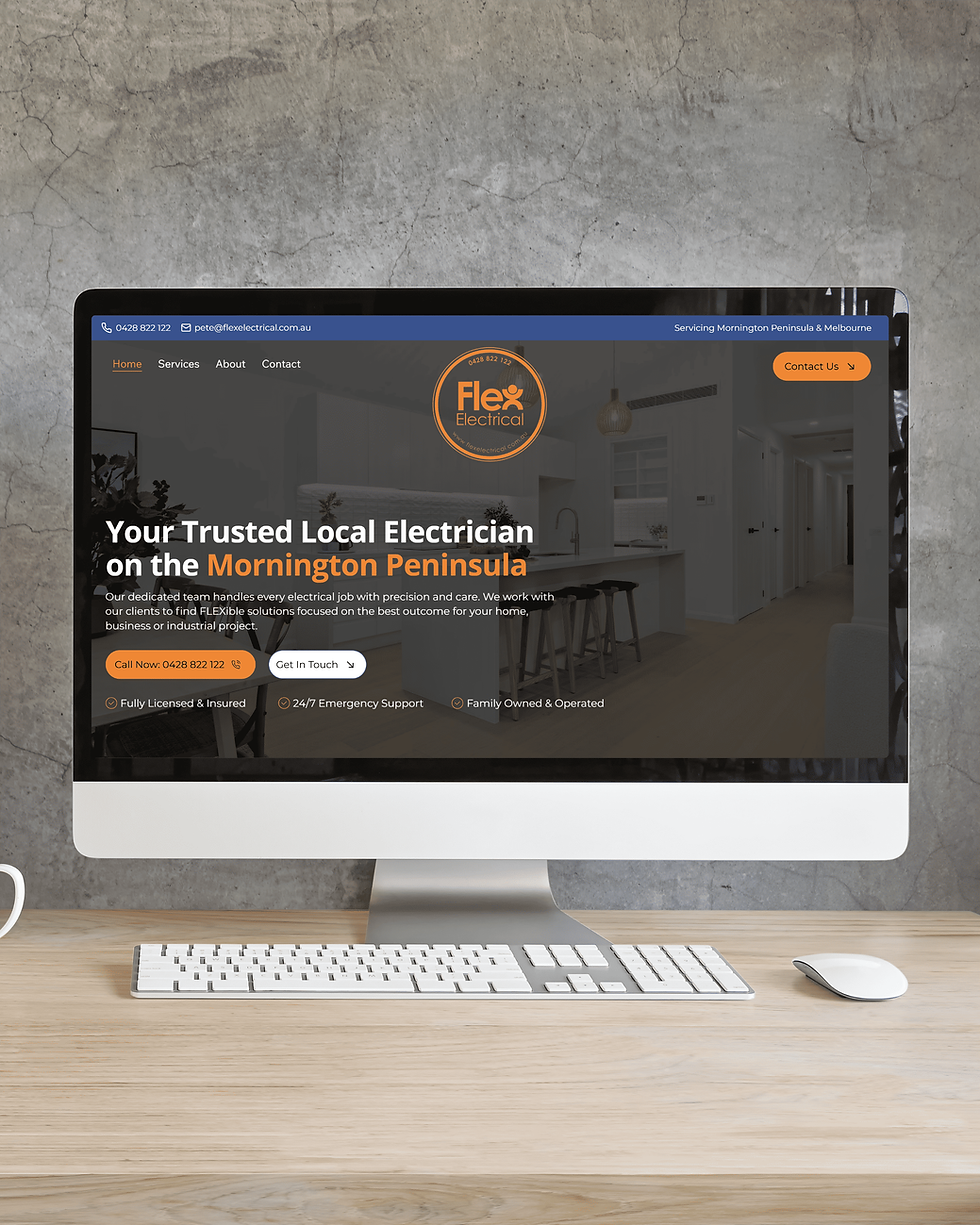 Desktop monitor on a wooden desk showing Flex Electrical website with orange logo, contact buttons, and Mornington Peninsula text created by Peninsula Design co the best website designer on the Mornington peninsula.