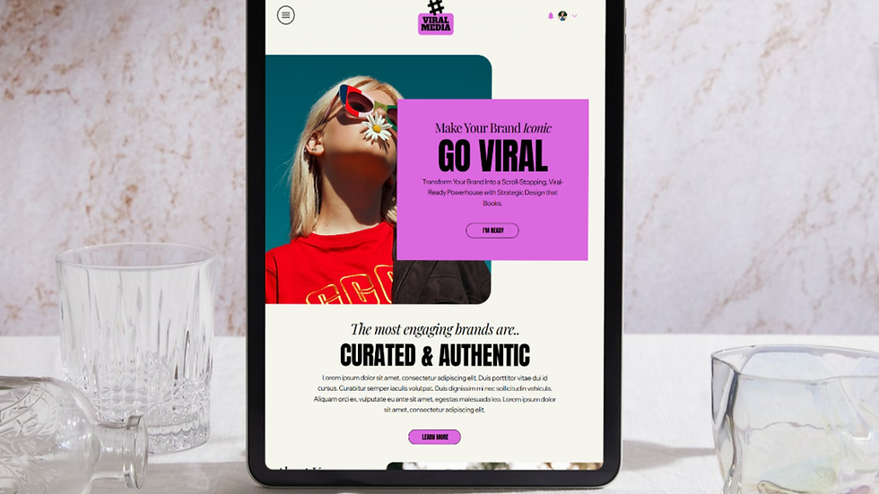 Tablet with a website open shows a woman in red and text "GO VIRAL" on a pink box. Glasses on a white table. Mood is modern.