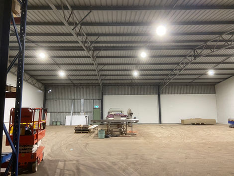 Spacious warehouse interior with bright lights and equipment