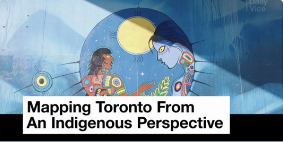 Colorful dancers in vibrant regalia with tassels, fringes, and patterns, dancing energetically on grass. The mood is lively and festive.