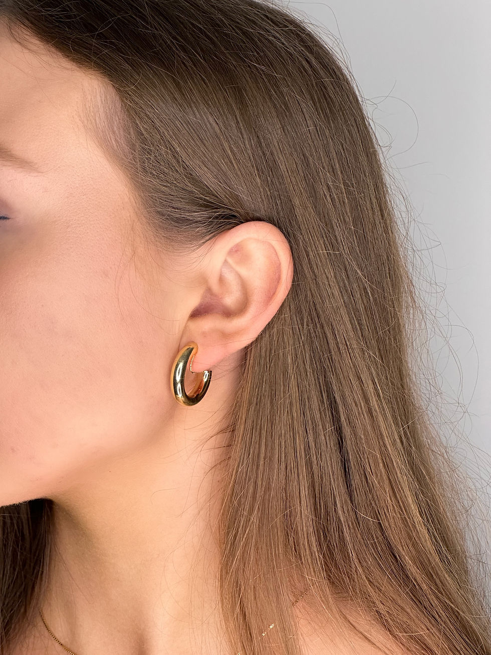 Close up of gold hoop clip on earrings on ear