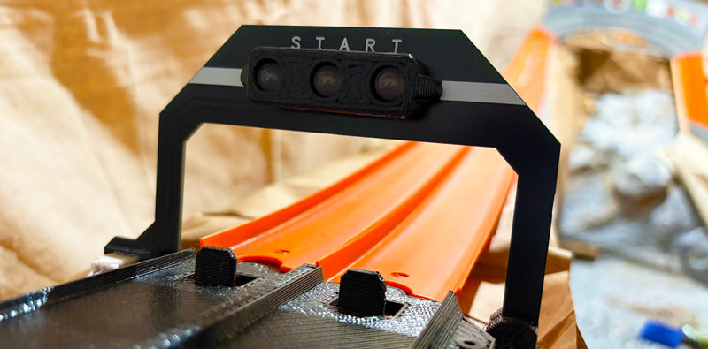 Eye-level view of a diecast car speeding on Timber Creek Speedway’s detailed race track