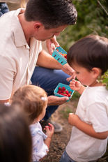 Family picking fresh berries together at a U-pick farm.