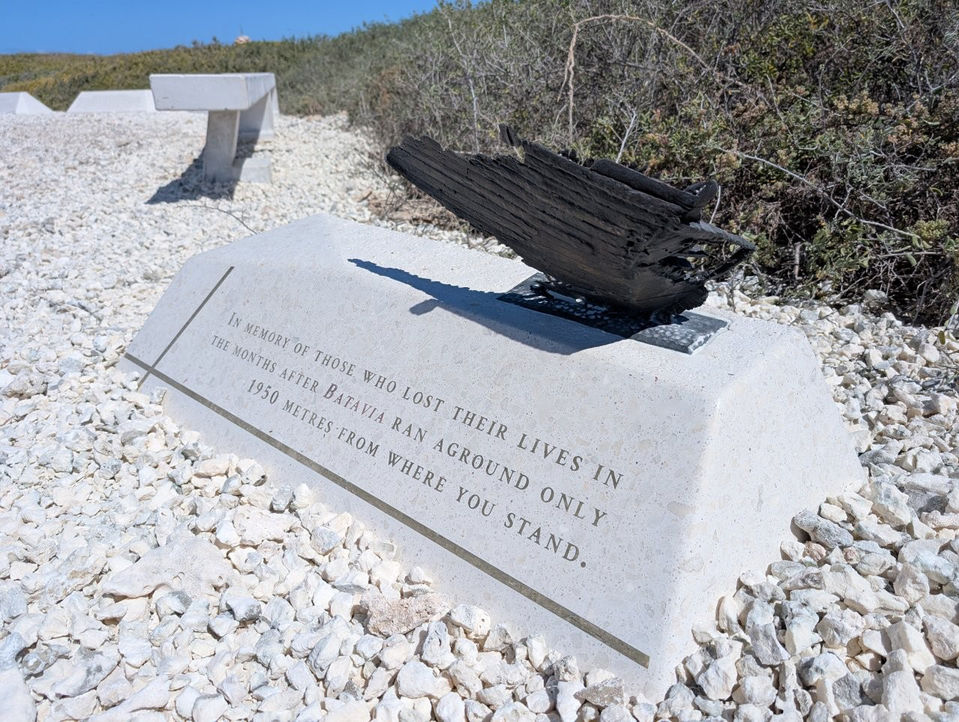 Bespoke concrete interpretive signage at Beacon Island featuring cast bronze sculpture of ship wreckage.