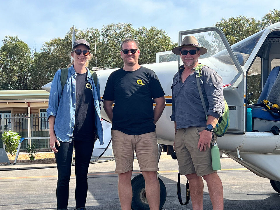 Armsign staff in front of aircraft on their site visit as part of the Beacon Island Interpretive project.