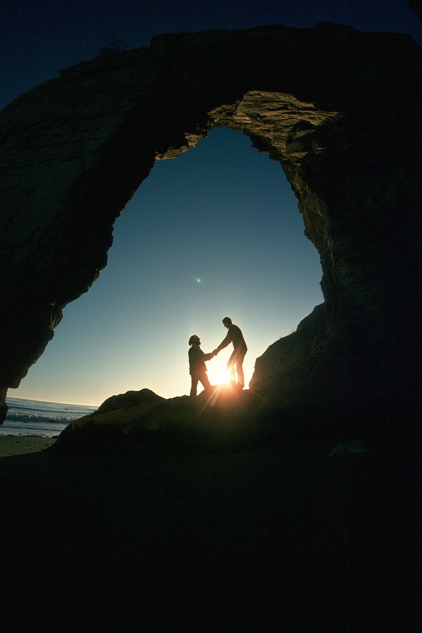 A couple at the mouth of a cave