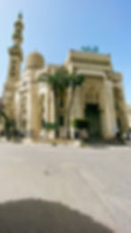 Stunning view of Abu Al Abbas Al Mursi Mosque in Alexandria, featuring its intricate architectural details and beautiful minarets against a clear blue sky.
