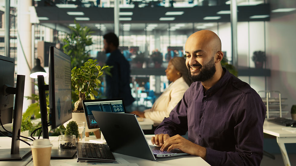 happy-man-office-reviewing-financial-graphs-celebrating-positive-kpis.jpg