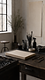 Mitología studio table with brushes, paper and abstract art materials.