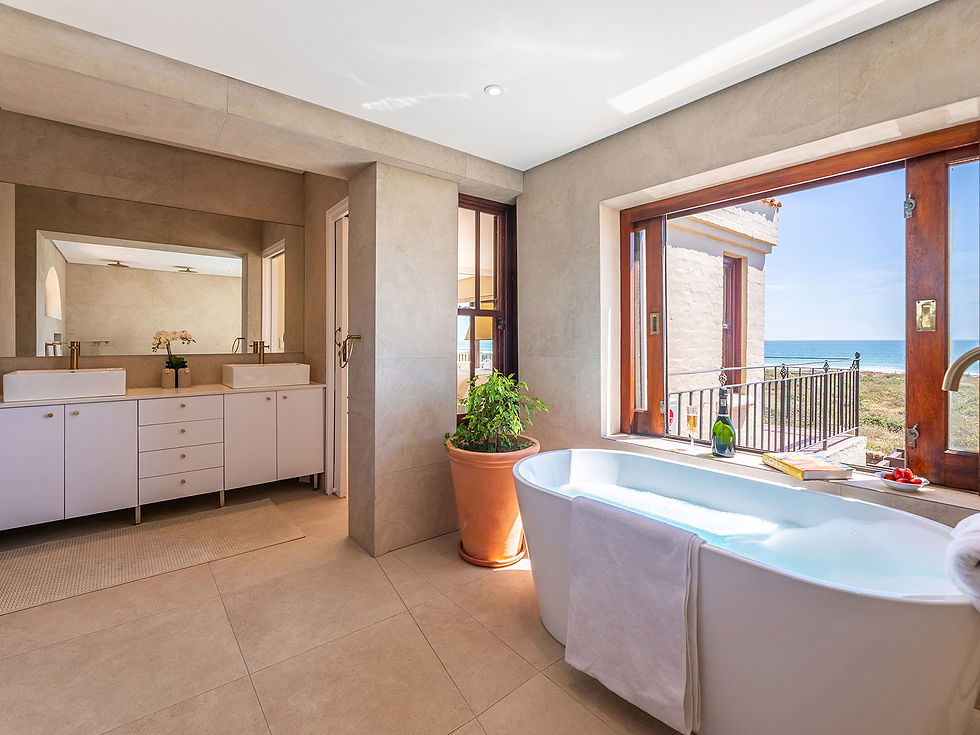 bath with ocean view and double vanity