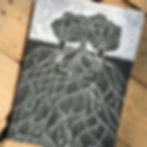 black and white lino printed soil art, picturing a tree with large underground roots.