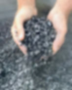 hands holding biochar made for Generation soil in bristol