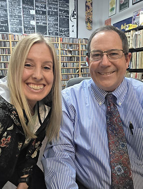 Smiling blonde woman and man in shirt and tie in office.