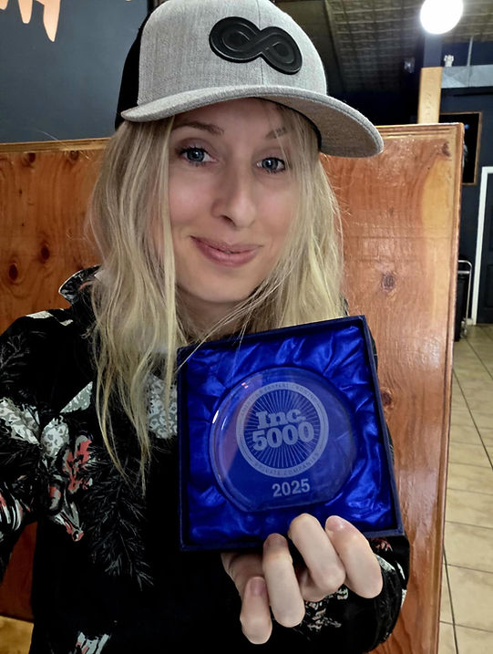 Amanda McKeen holding an award from the Inc5000