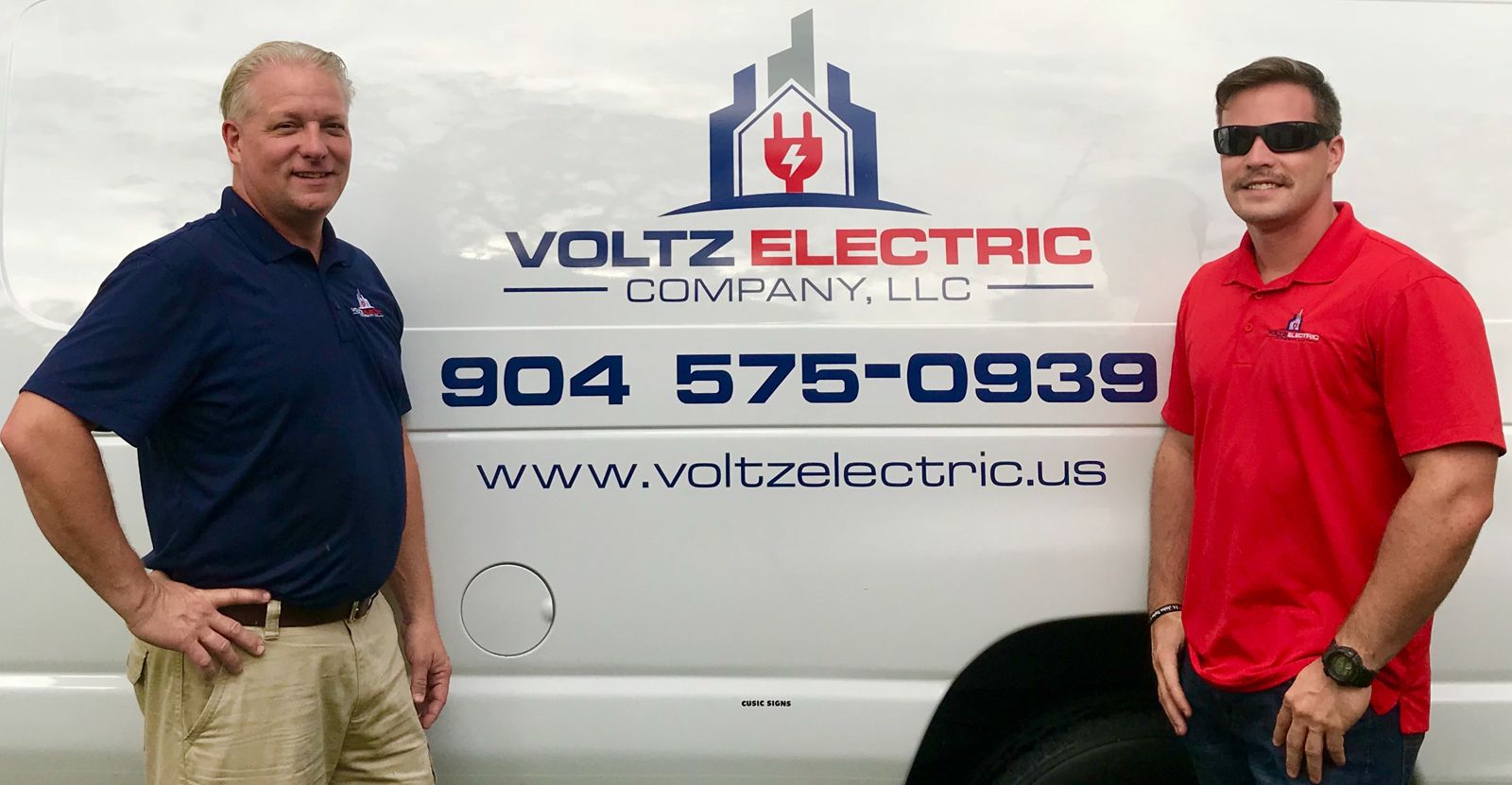 Tim and Kyler Voelz beside Van 101, the first Voltz Electric van