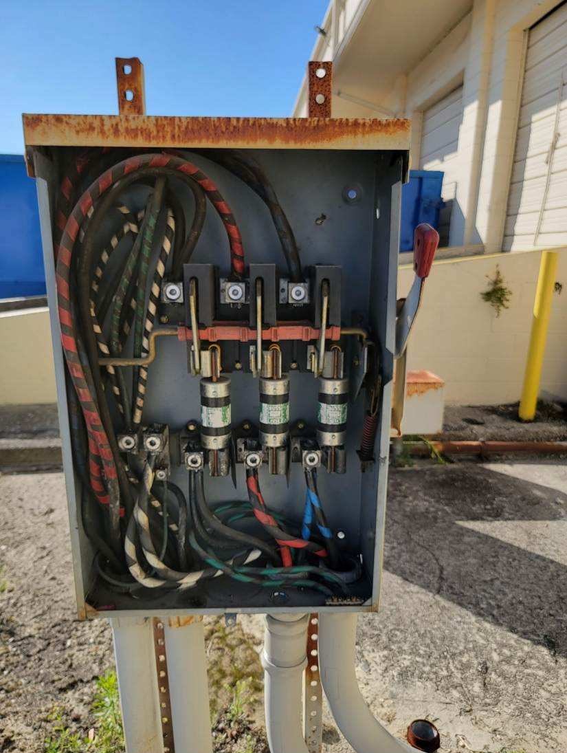 Before: corroded fused disconnect with weathered conductors
