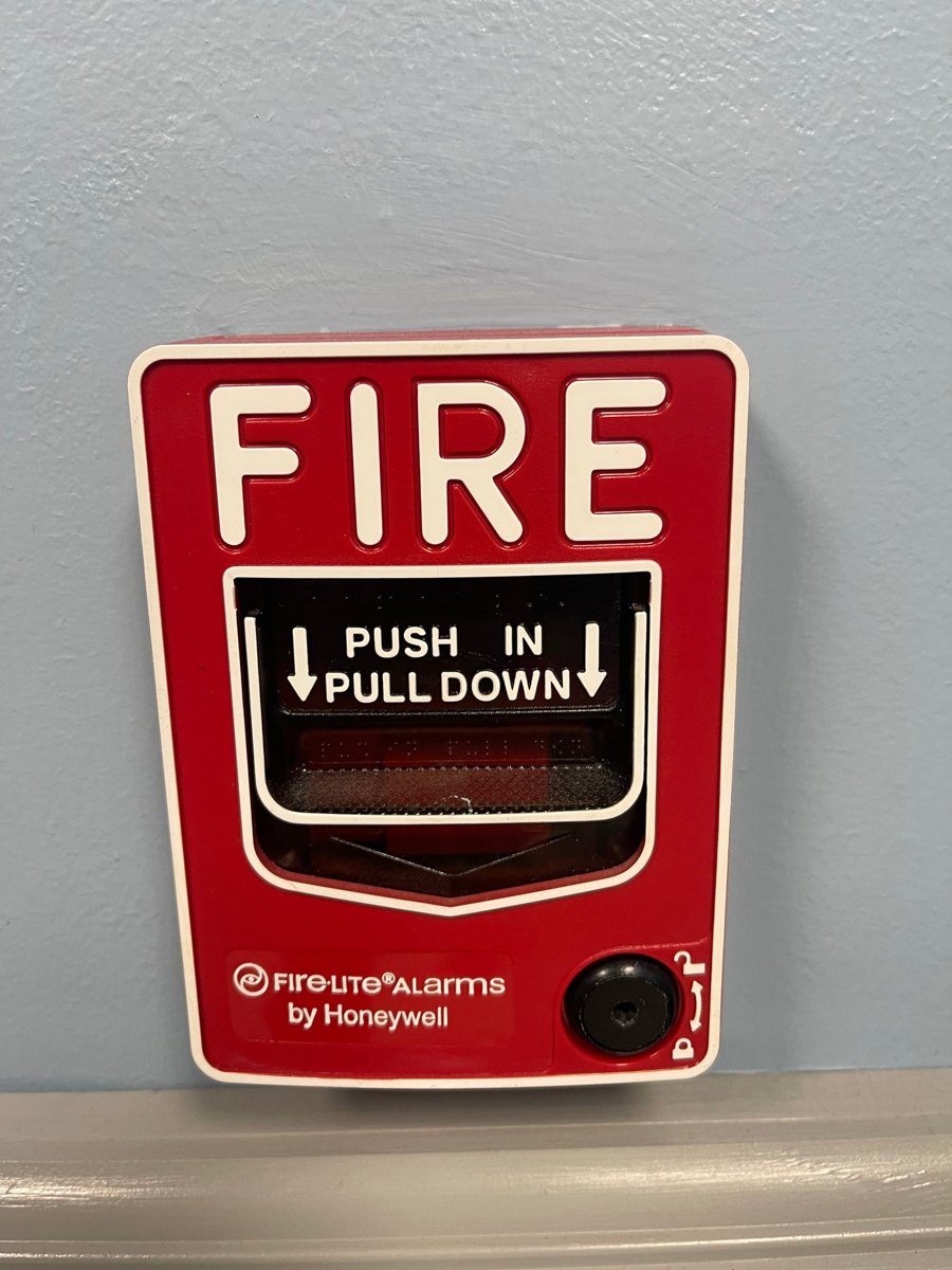 Fire alarm pull station mounted on a commercial wall