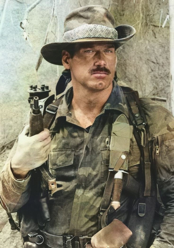 Jesse Ventura dressed in camo with a weapon