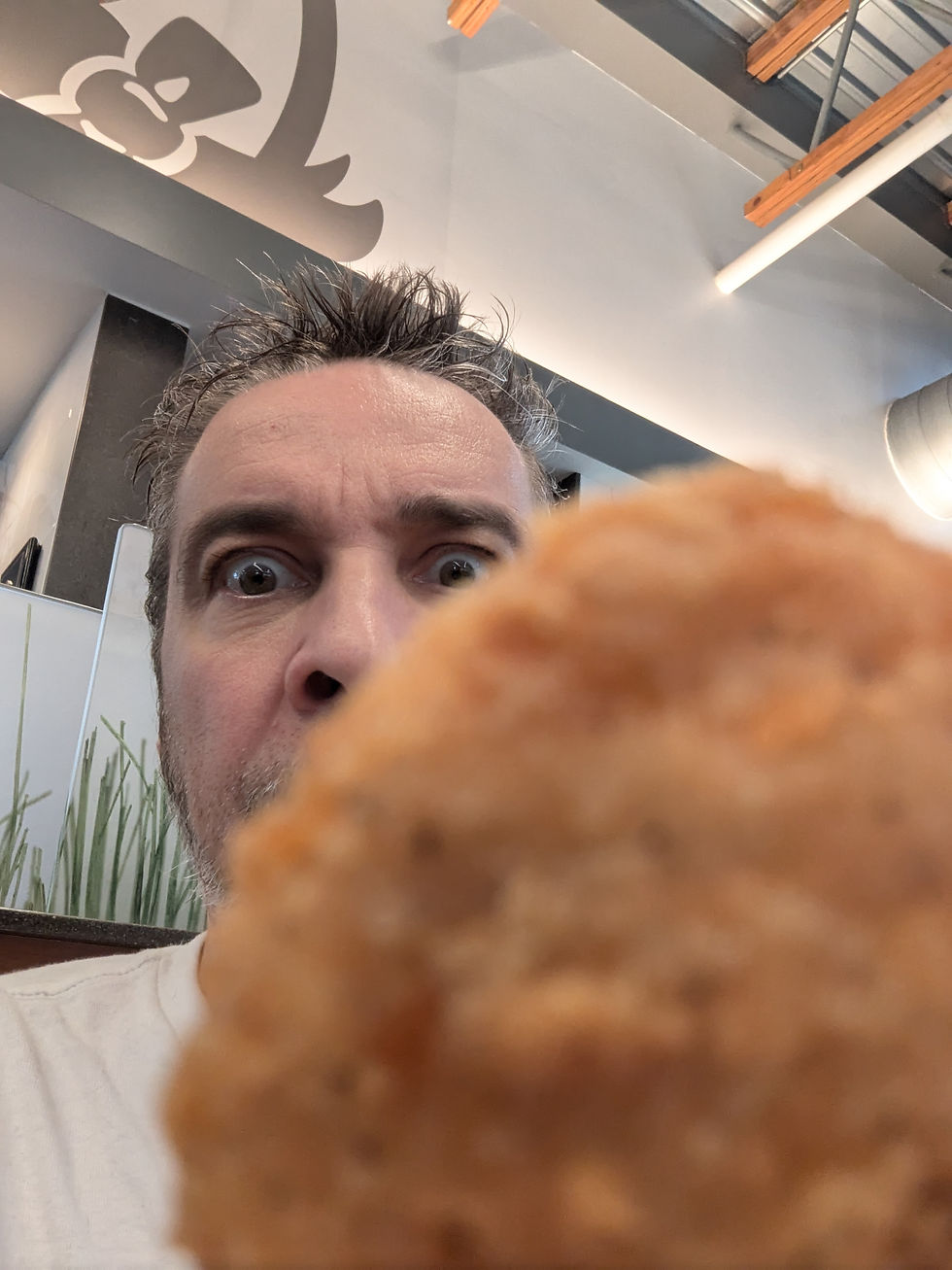 Nick holding a chicken nugget up to the camera lens