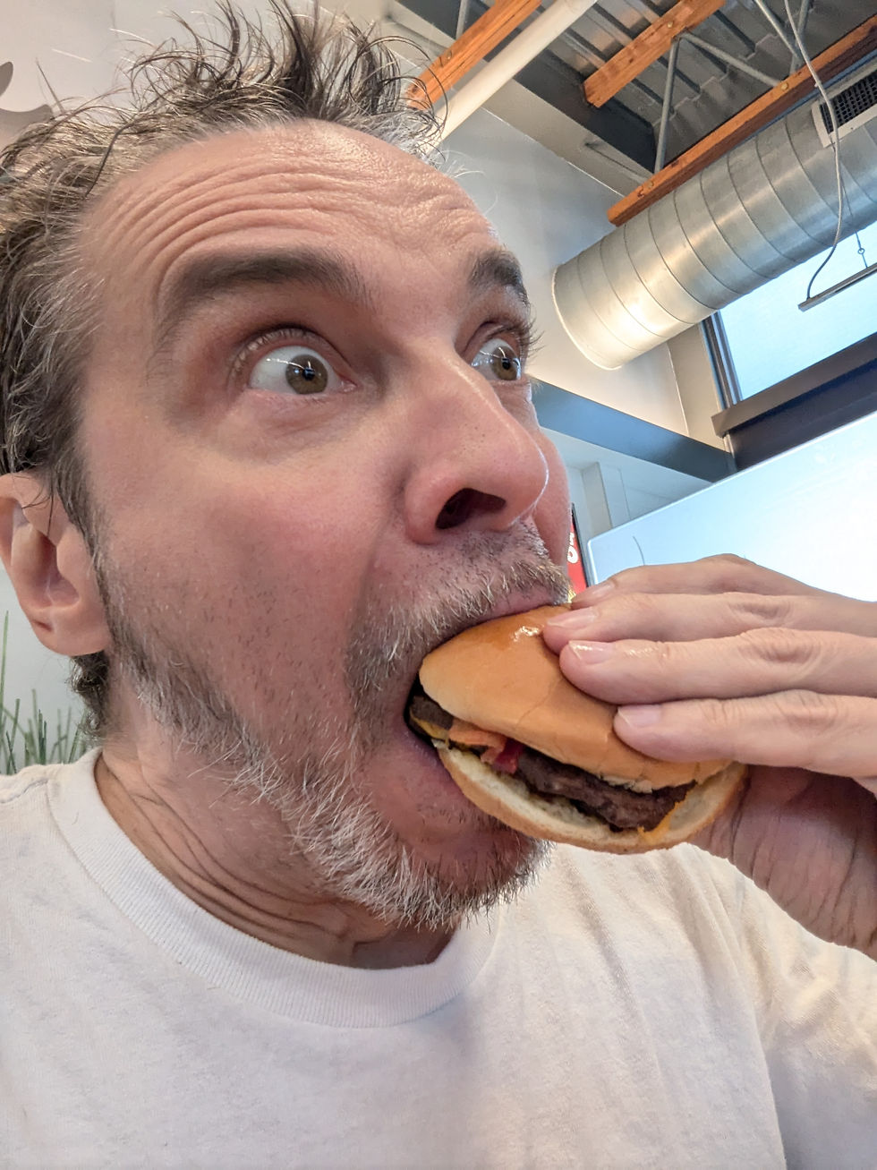 Nick eating a cheeseburger