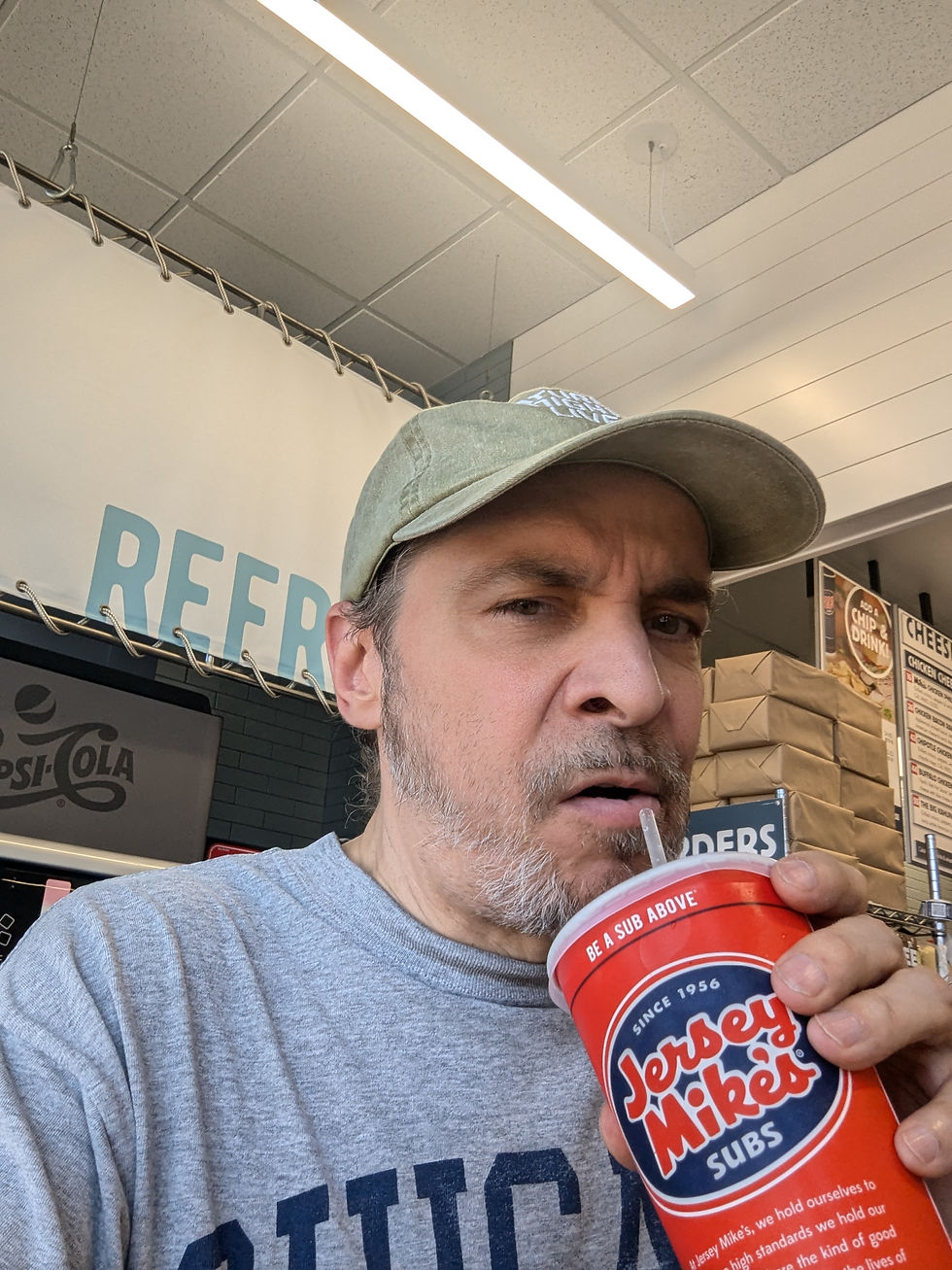 Nick drinking from a Jersey Mike cup