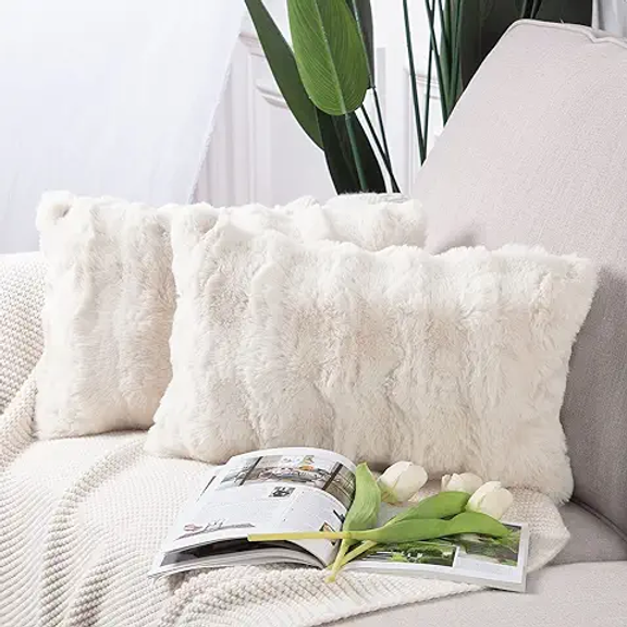 pretty decorative pillows on a pretty couch with flowers and a magazine