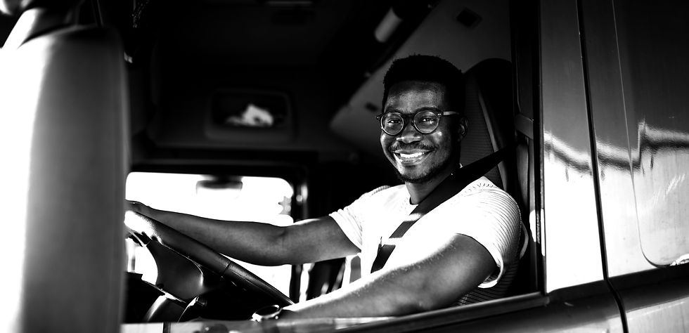 Young handsome African American man working in towing service and driving his truck_edited