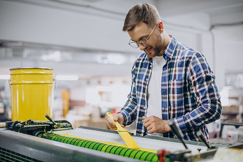 man working printing house with paper paints
