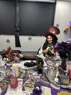 Woman in witch hat at a witch-themed party table
