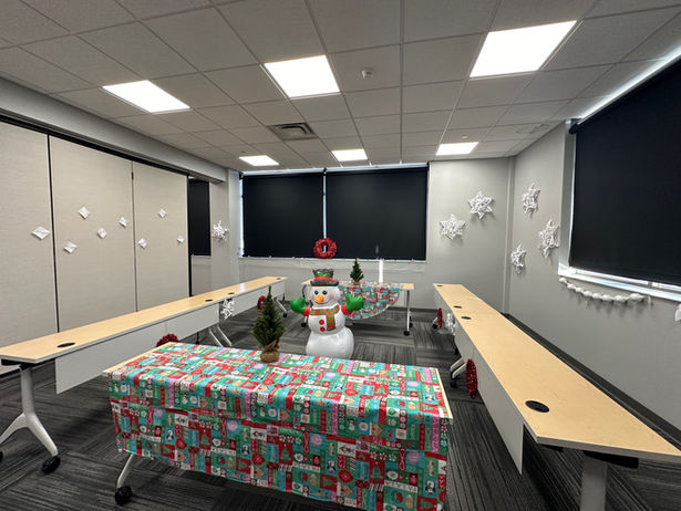 Office room decorated for holiday events with a snowman and festive tables