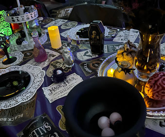 Spooky event table with cauldron, coffin, and Hocus Pocus sign