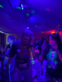 People dancing at an event with blue lights