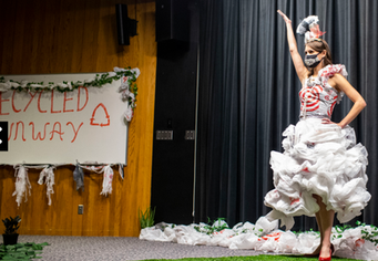 Model in recycled plastic bag dress at Recycled Runway event