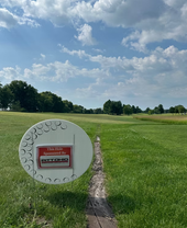 Golf course with tee marker and red sign