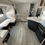 Thumbnail: Interior of a new RV with a sofa, kitchen, and dining area New 2025 Prime Time Avenger 21RBSLE.