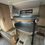 Thumbnail: Bunk beds inside RV with cabinets and window, light wood New 2025 Keystone Springdale.