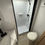 Thumbnail: RV interior bath detail with shower, toilet, and sink. LOCAL RV DEALERSHIP