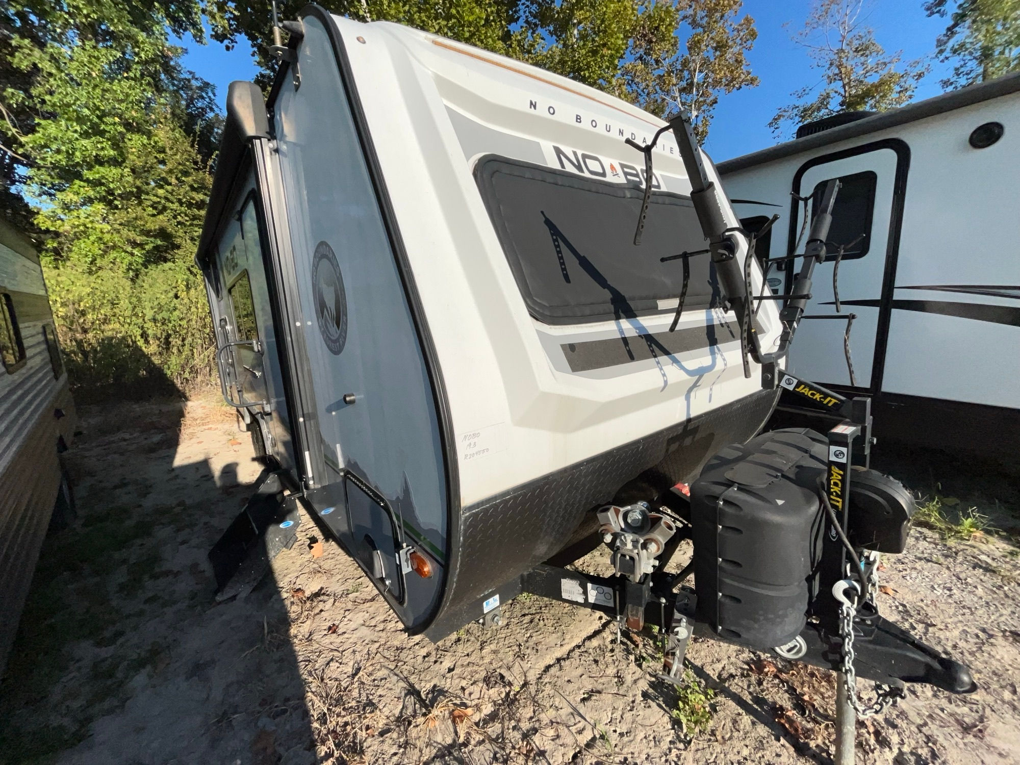 White and black RV with large window. LOCAL RV DEALERSHIP
