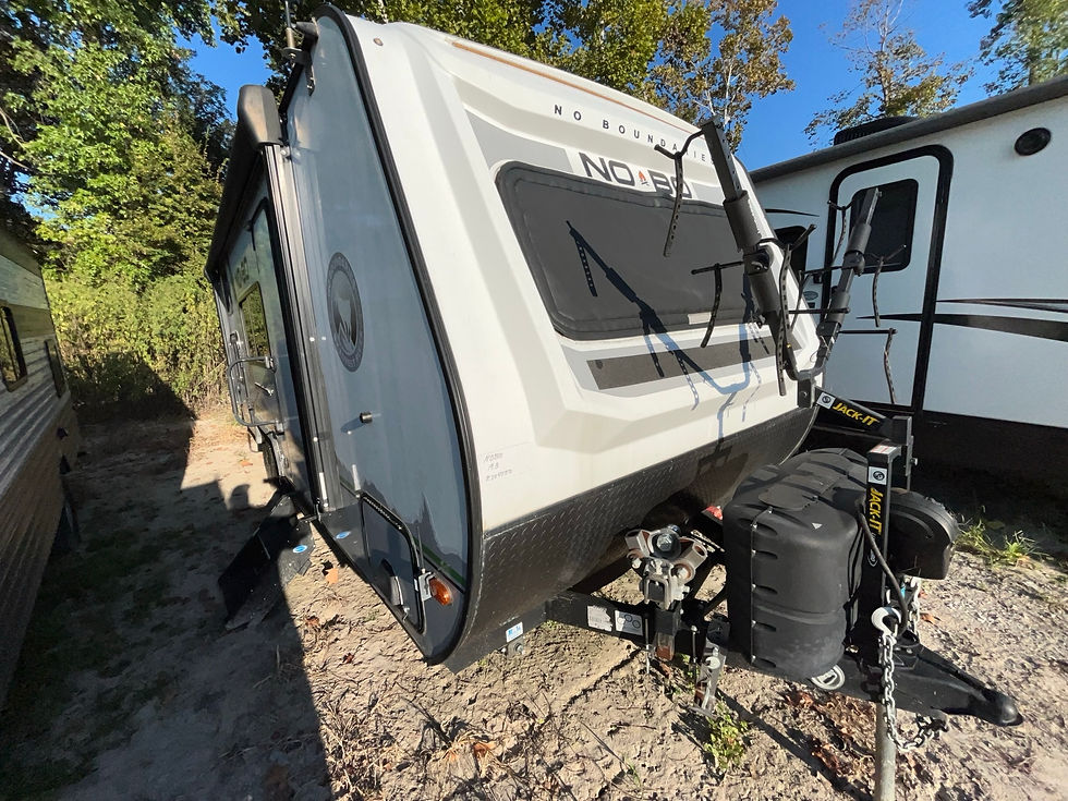 White and black RV with large window. LOCAL RV DEALERSHIP