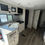 Thumbnail: RV kitchen with sink, stove and cabinets; LOCAL RV DEALERSHIP.