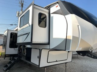White RV with open door. New 2026 Axiom RV Vendetta V4250SP ready for travel.