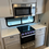 Thumbnail: RV kitchen interior with microwave, stove and cabinets, LOCAL RV DEALERSHIP