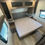 Thumbnail: Bedroom interior of a RV with bed, cabinets, and windows. LOCAL RV DEALERSHIP
