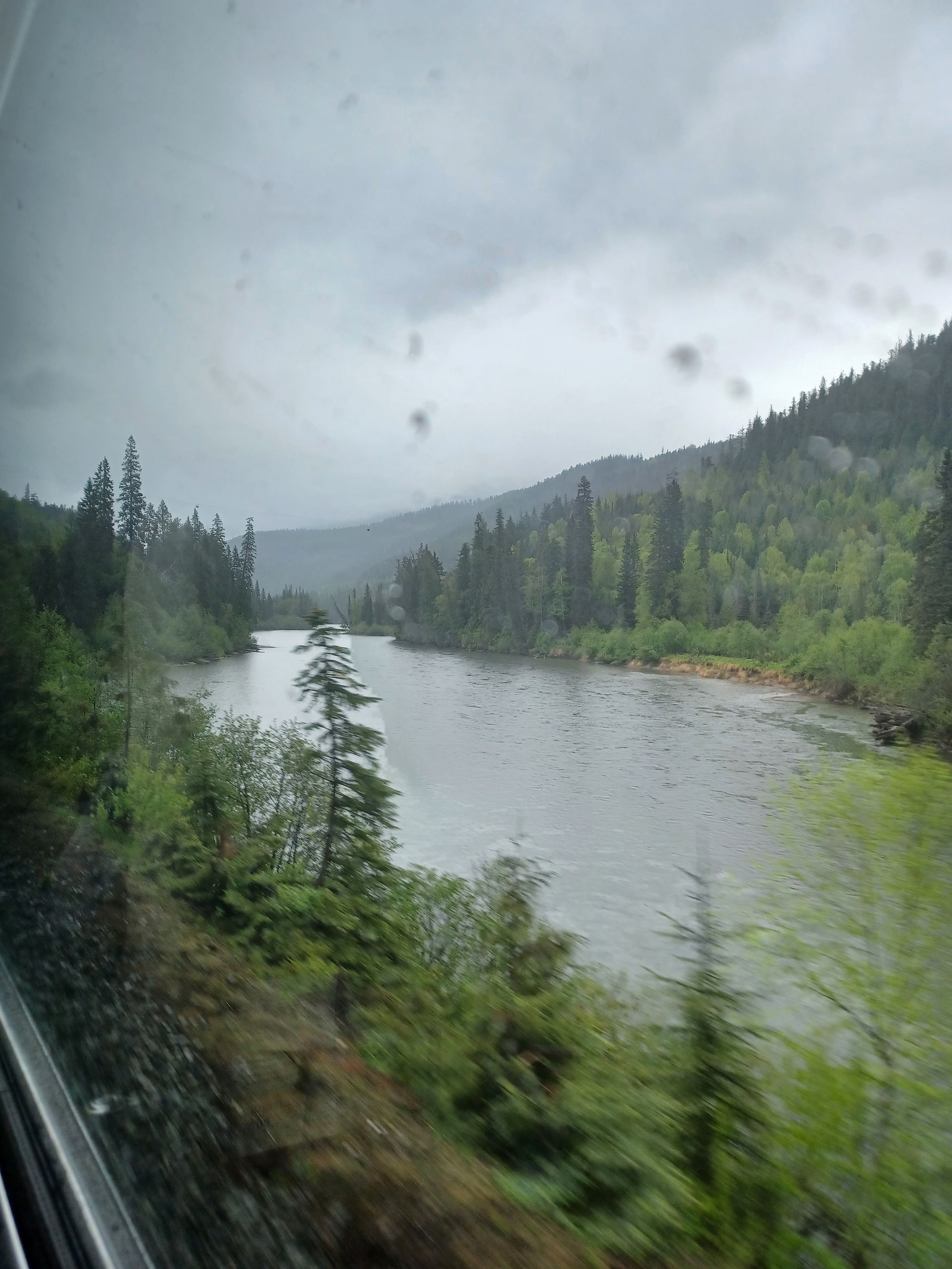 Rain on window, view of river