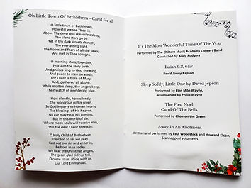 a 2 page spread inside a christmas concert programme with hymn lyrics and decorative berry and fern branches in the corners